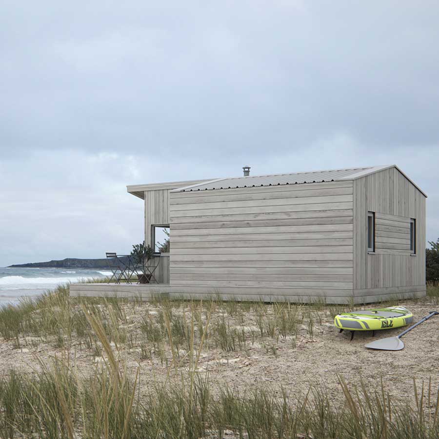CGI of a timber-clad beach cabin situated in a country park in the UK with a cloudy sky